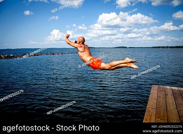 Man jumping into sea
