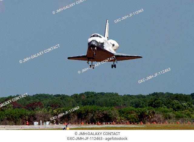 Space Shuttle Discovery is moments away from touchdown on runway 15 of the Shuttle Landing Facility at NASA's Kennedy Space Center