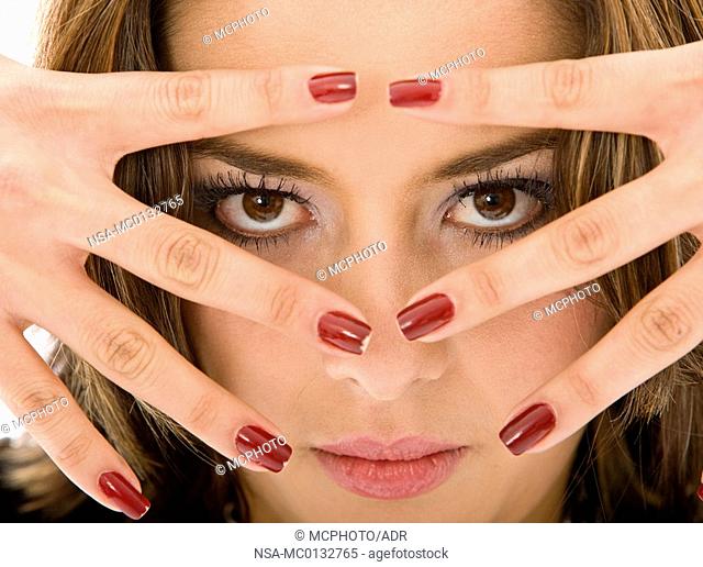 woman peeking between her fingers