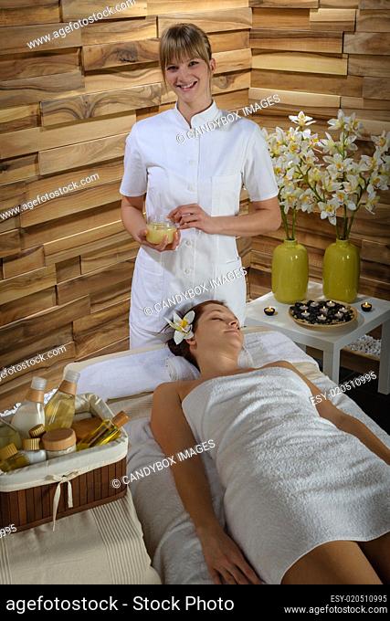 Woman and masseur at luxury spa room