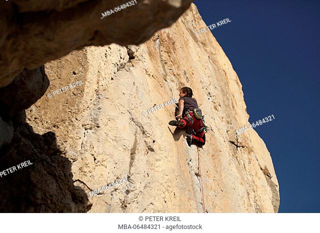 Climber in the climbing area Pas de la Mala Dona, Costa del Garraf, Catalonia, Spain