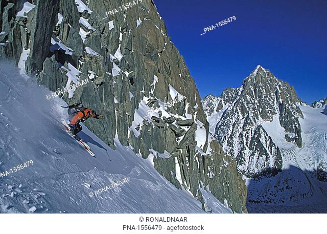 Mountain guide Edward Bekker skiing down the Grand Montets piste, looking to the Aiguille de Chardonnette, France