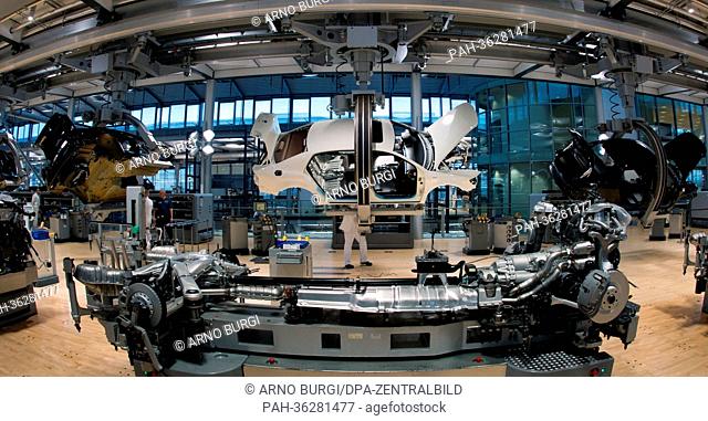 Employees of car manufacturer Volkswagen (VW) work on a VW Phaeton at VW's transparent factory in Dresden, Germany, 16 January 2013