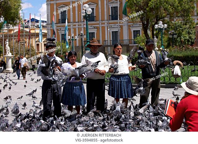 llocals making pictures with pigeons, Plaza Murillo, government district La Paz, the political capital of Bolivia is the highest capital city in the world