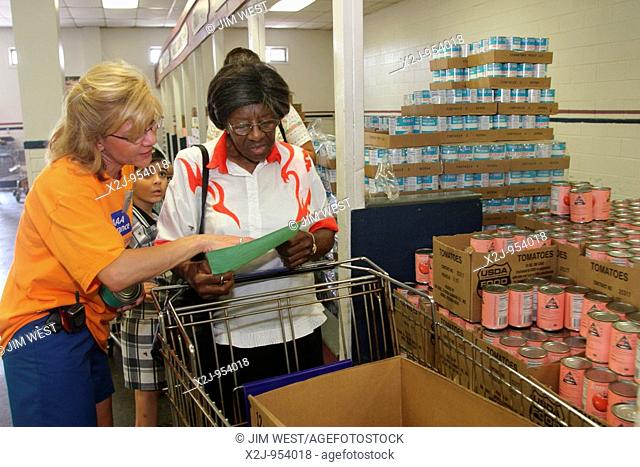 Detroit, Michigan - Volunteers from AAA Insurance help out at the West Side Food Center, a food bank operated by Focus: HOPE