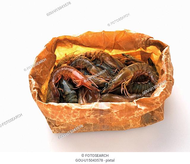 Shrimps on paper bag, high angle view