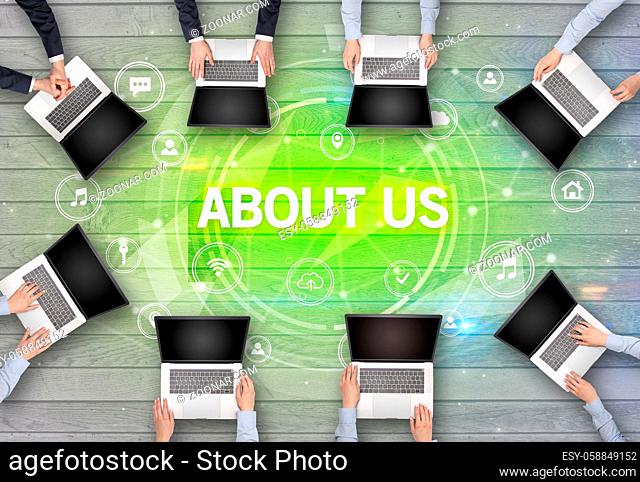 Group of people having a meeting with ABOUT US insciption, social networking concept