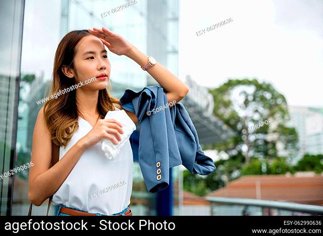 Angry female having sunstroke skin damage from sun UV city air pollution outside on street, Overheating Asian beautiful business woman drying sweat her face...
