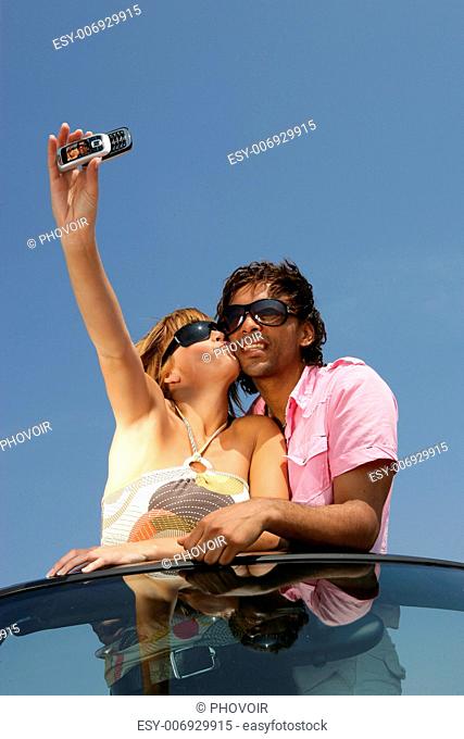 Couple taking a self-portrait with a cameraphone