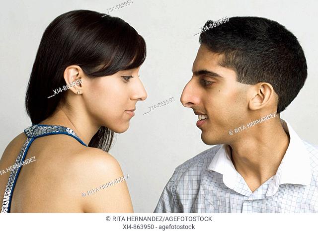 close up of a couple having a conversation  Both showing profiles