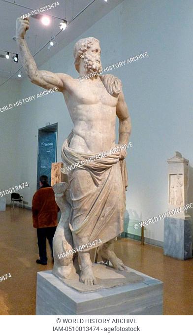 Statue of Poseidon made of Parian marble found on Milos along with the statue of Amphitrite. In his raised right hand he will have held the trident and next to...