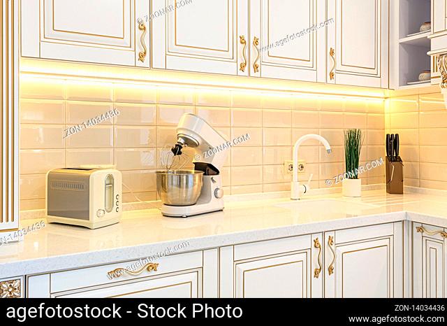 closeup r of neoclassical style white and gold wooden kitchen with island in luxury home