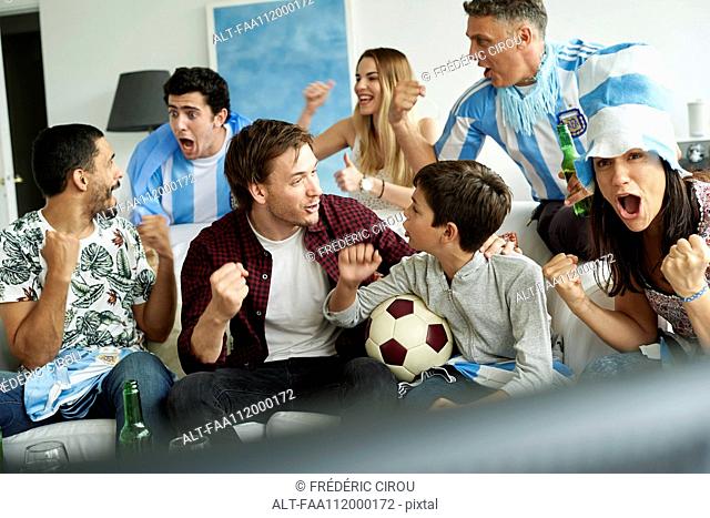 Argentinian football fans watching football match at home