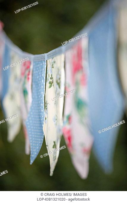 England, West Midlands, Edgbaston, Fabric bunting hanging in a garden