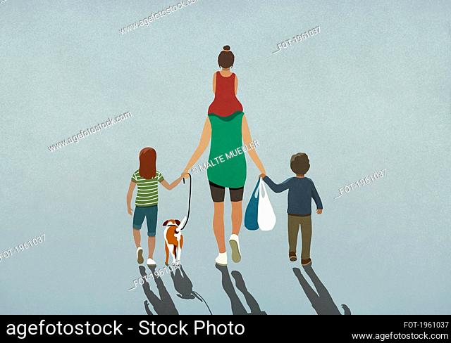 Family with dog holding hands and walking with grocery bags