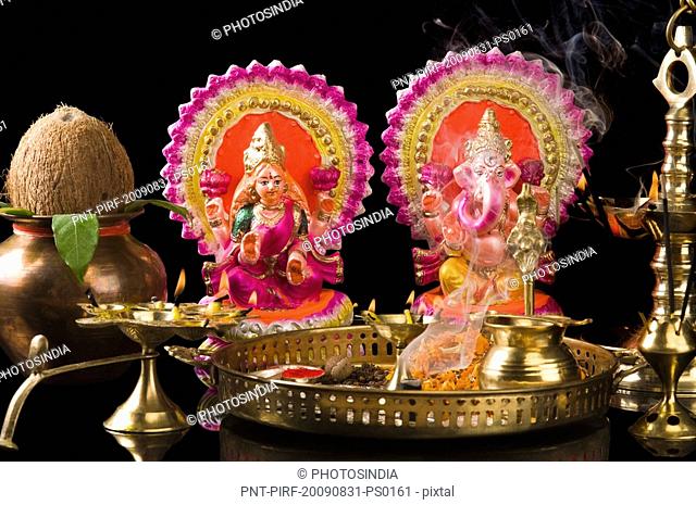 Diwali thali in front of idols of Lord Ganesha and Goddess Lakshmi