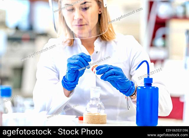 research of dangerous chemical substances in the biochemical laboratory of the Scientific Institute. Use protective equipment, glass face mask and rubber gloves