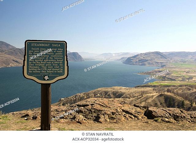 The tourism information sign describing the Gold Rush and Steamboat Saga periods of the British Columbia history with the view of Kamloops Lake