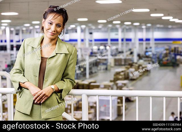 Portrait of businesswoman on balcony in warehouse