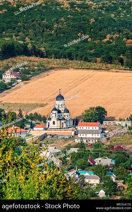 Landscape view with Capriana Monastery and the village around. Winter Church visible at center was built in Neo-Byzantine style in 1903
