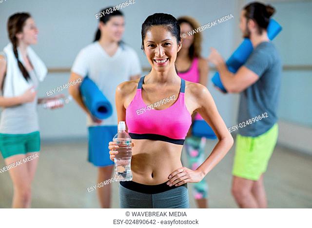Portrait of woman holding water bottle