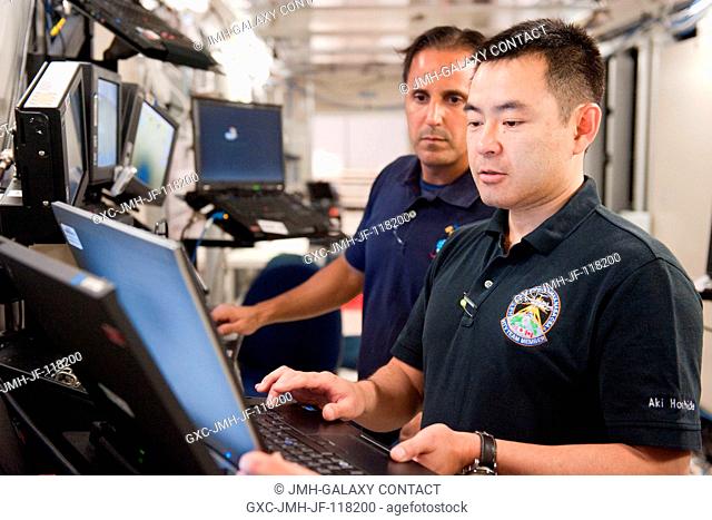 Japan Aerospace Exploration Agency (JAXA) astronaut Akihiko Hoshide (foreground), Expedition 3233 flight engineer; and NASA astronaut Joe Acaba