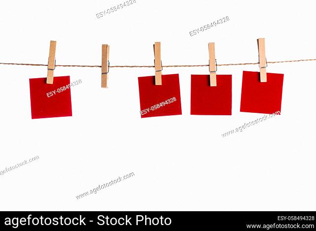 Red Memo papers with clothespins on a leash. Isolated on white background. I love you copy space for letters