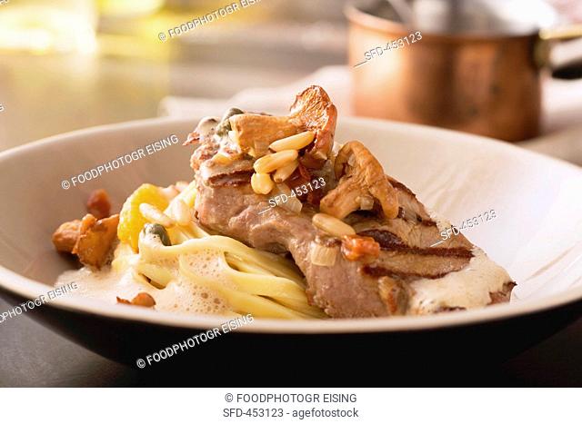 Veal with pasta and orange and chanterelle mushroom sauce