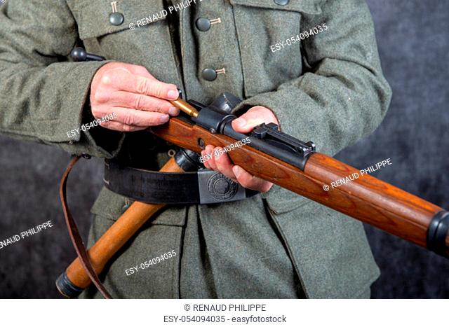 close up of WW II German soldier with a rifle and a grenade