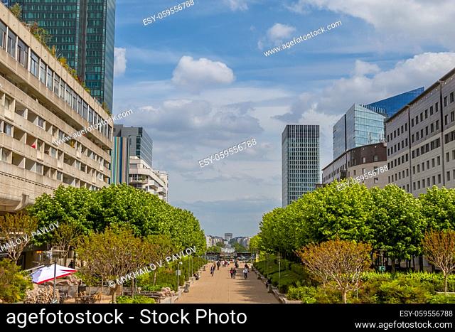 France. Paris. Pedestrian part of the district of La Defense. Skyscrapers and clouds
