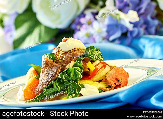 meat salad with green tomatoes on the plate blue background lot of food recipes Food being prepared and cooked in a contemporary kitchen