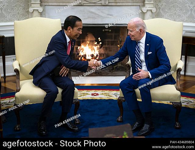United States President Joe Biden shakes hands with President Joko Widodo of Indonesia, in the Oval Office of the White House in Washington, DC, US, on Monday