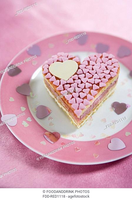 Heartshaped pink cake on plate