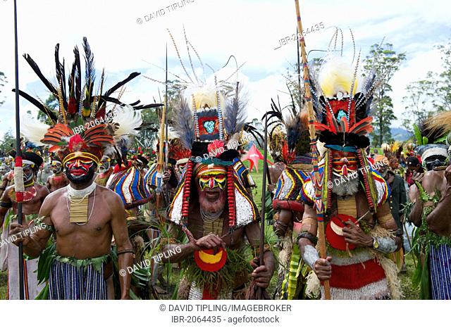 Men of Mendi from the Southern Highlands, wearing headdress with King of Saxony plumes and breast shield of Superb Bird of Paradise plus plumes from Blue bird...