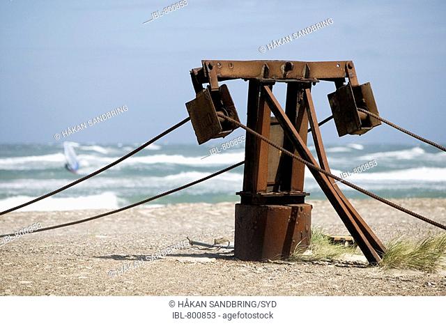 Old rusty winch on the beach