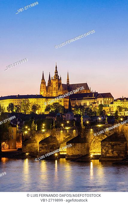 Prague Castle St Vitus Cathedral Charles bridge and Vtlava River illuminated at dusk Czech Republic