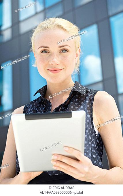 Young woman using digital tablet outdoors
