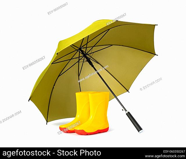 green umbrella and gumboots on white background