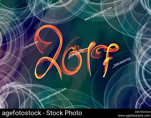 Happy new year 2017 isolated numbers lettering written with fire flame or smoke on colorful background