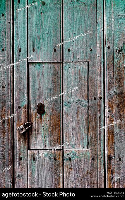 Old wooden door with a locked hatch in Mallorca, Spain