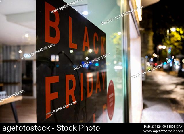 24 November 2023, Berlin: A Black Friday poster hangs in the window of an eyewear store on Schloßstraße, the main shopping street in Berlin's Steglitz district