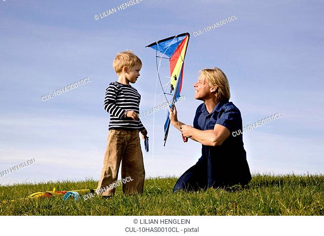 Boy and father put together a Kite