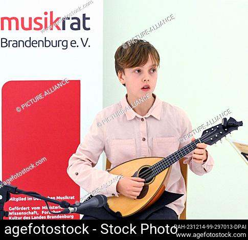 14 December 2023, Brandenburg, Potsdam: 12-year-old Milan Jürgens from the ""Bela Bartok"" music school in Berlin plays pieces by Raffaele Calace and Francesco...