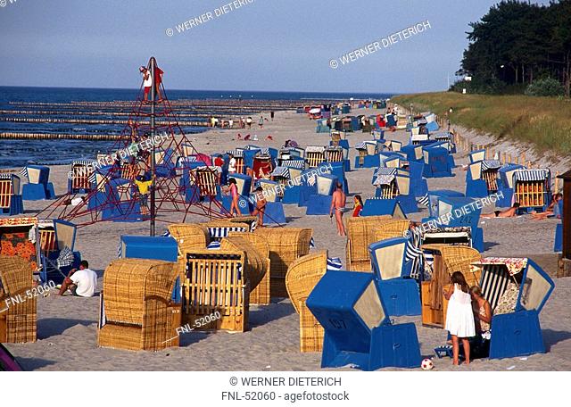Tourists and wicker chairs on beach, Mecklenburg-Vorpommern, Germany