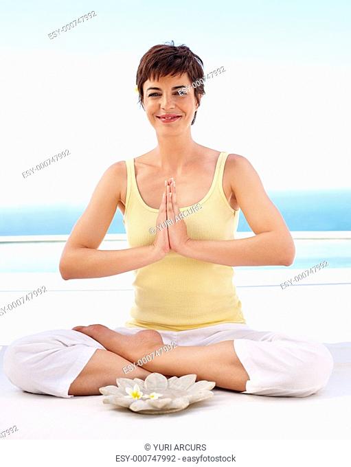 Happy young female sitting in the lotus position