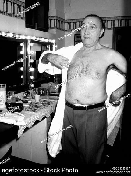 Italian television host Pippo Baudo get dressed in the backstage. Italy, 1990s