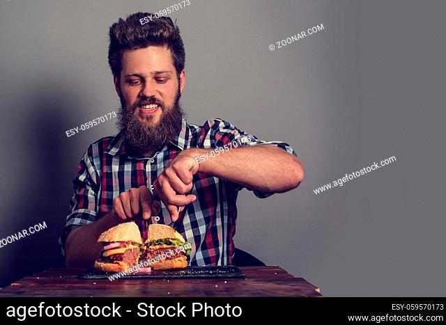 Man eating fresh self made burger close up