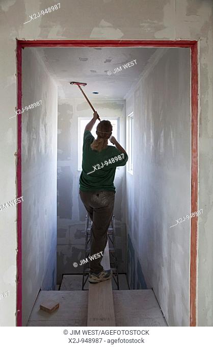 Gretna, Louisiana - Alison Hendley, a volunteer from the Marin Interfaith Council in California, repairs a house damaged by Hurricane Katrina  The owner of the...