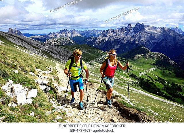 Hikers on the ascent from the Prato Piazza to the summit of the Dürrenstein, in the background Monte Cristallo and the Three Peaks of Lavaredo, Sexten Dolomites