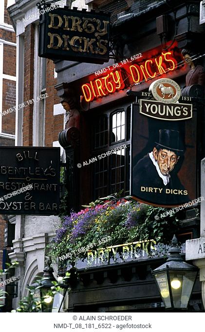 Neon signs at the entrance of a bar, Dirty Dick's, Bishopsgate, London, England